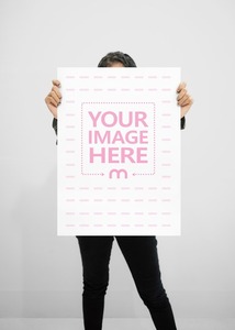 A Mockup of an A2 Paper With a Woman Cover Herself Behind it