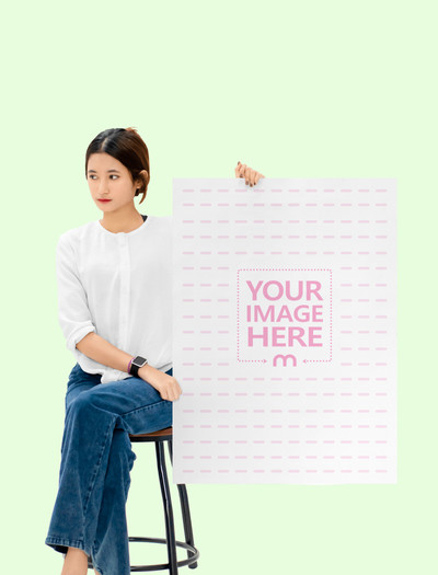 A1 Paper Mockup With a Sitting Woman Holding it on Her Side