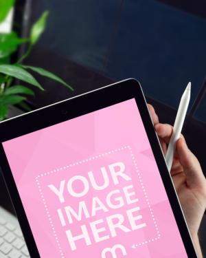 Closeup iPad and Apple Pencil in Hand Mockup Generator