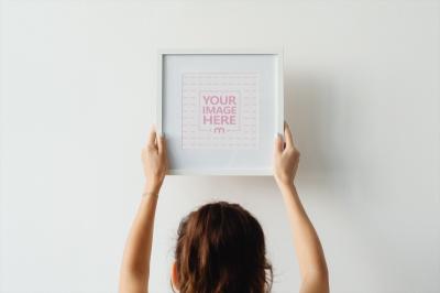Hanging Picture Frame on White Wall PSD Template