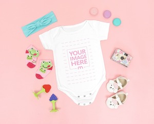 Onesie Mockup of a Baby Surrounded by Girly Accessories