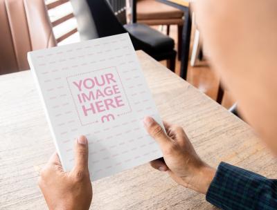 Paperback Book Mockup Held by a Person