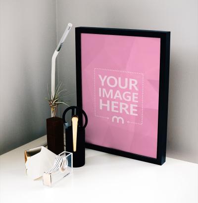 Portrait Poster Frame Standing on Desk Mockup Generator