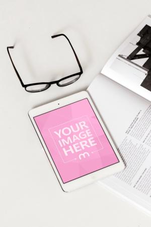 White iPad on Desk with Magazine Mockup Generator
